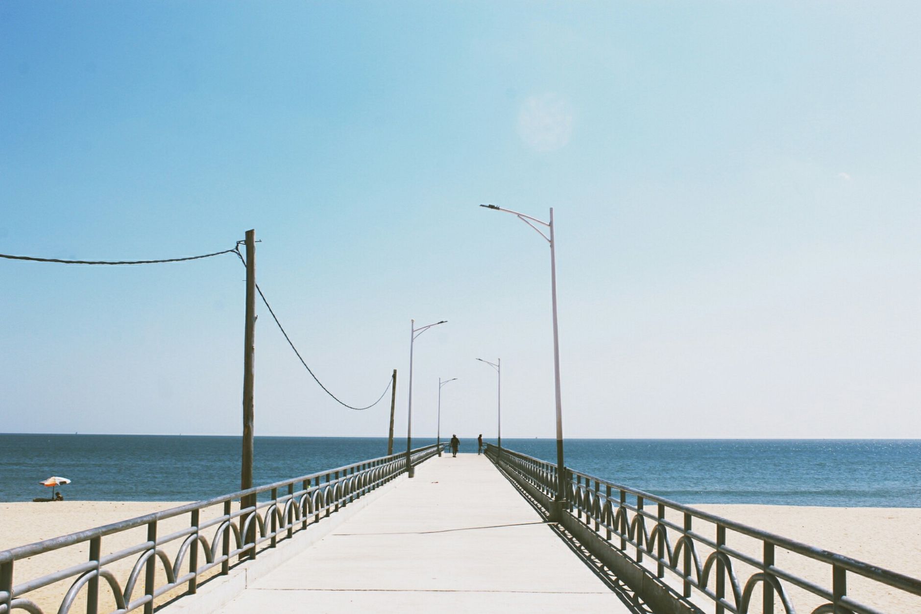 A serene view of a boardwalk extending towards the ocean, perfect for travel and relaxation. — Trójmiasto