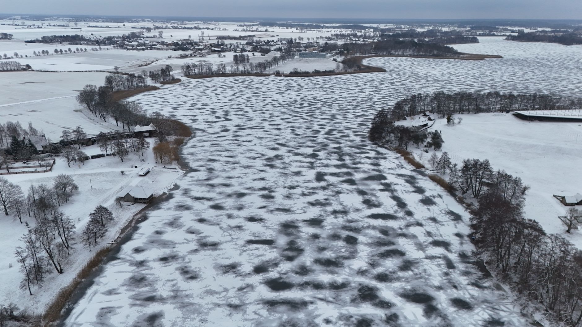 Aerial view of a snowy and frozen river landscape in Poland during winter. — Trójmiasto