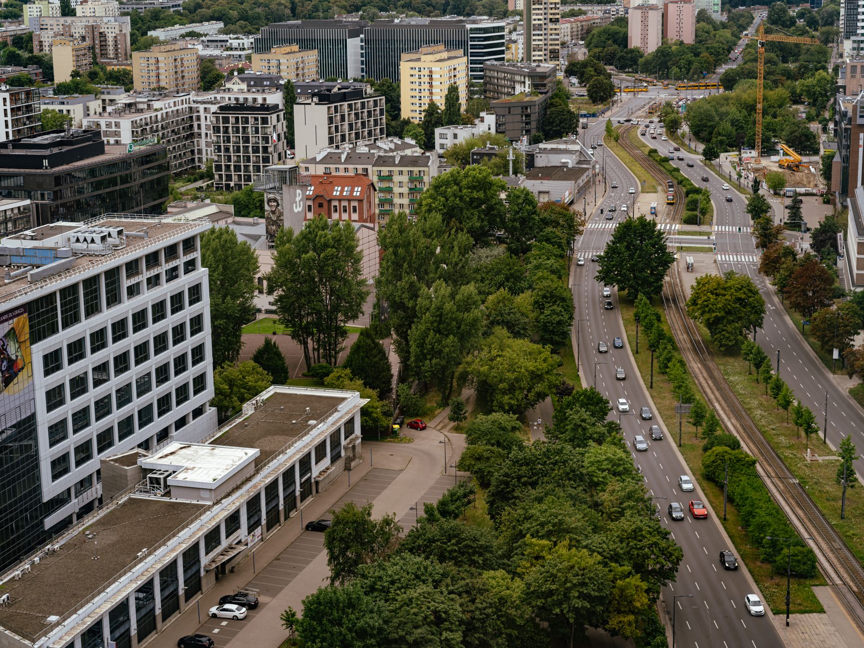 Aerial view of Warsaw city showcasing modern architecture, streets, and greenery. — Trójmiasto