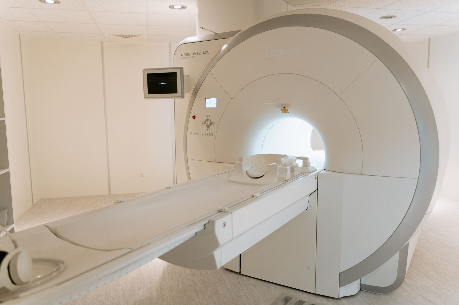 A state-of-the-art MRI scanner in a well-lit hospital room, ready for patient use. — Trójmiasto