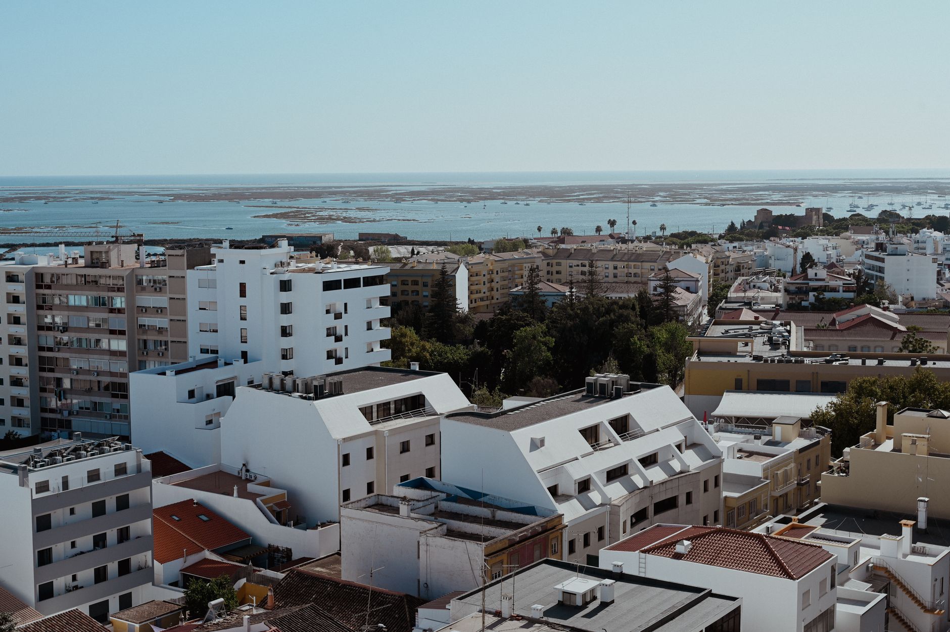 Overlooking the urban landscape of Faro, Portugal, with a glimpse of the distant Atlantic Ocean. — Trójmiasto