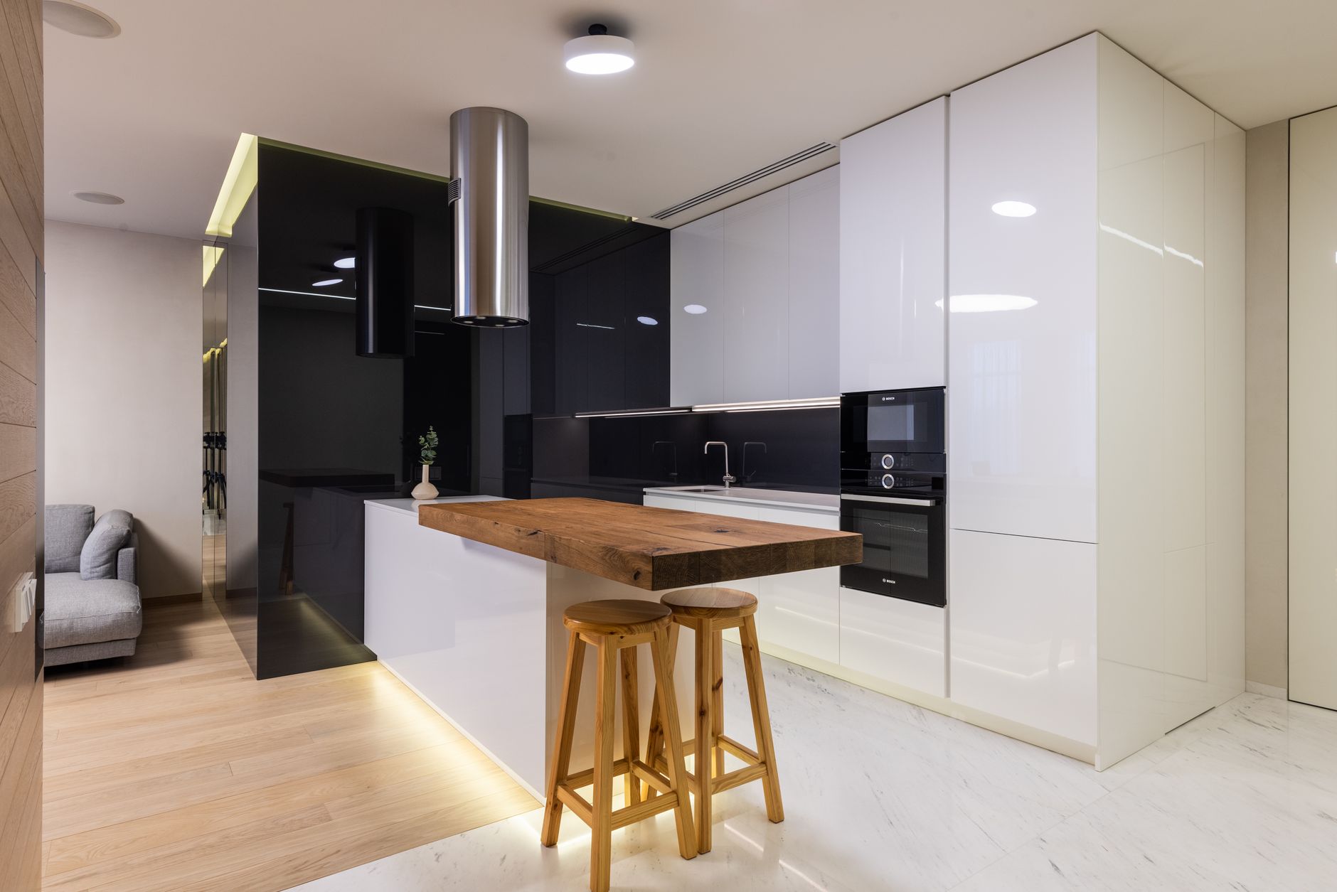 Interior of modern apartment with kitchen zone furnished with glossy cabinets and living area with sofa — Trójmiasto