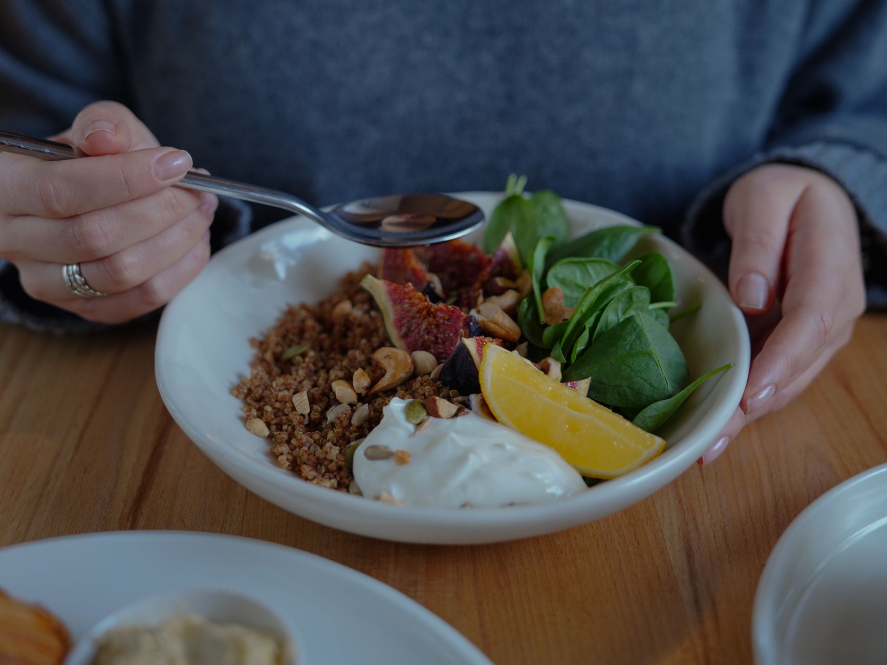 A vibrant brunch bowl with fruit, greens, and nuts for a nutritious meal. — Trójmiasto