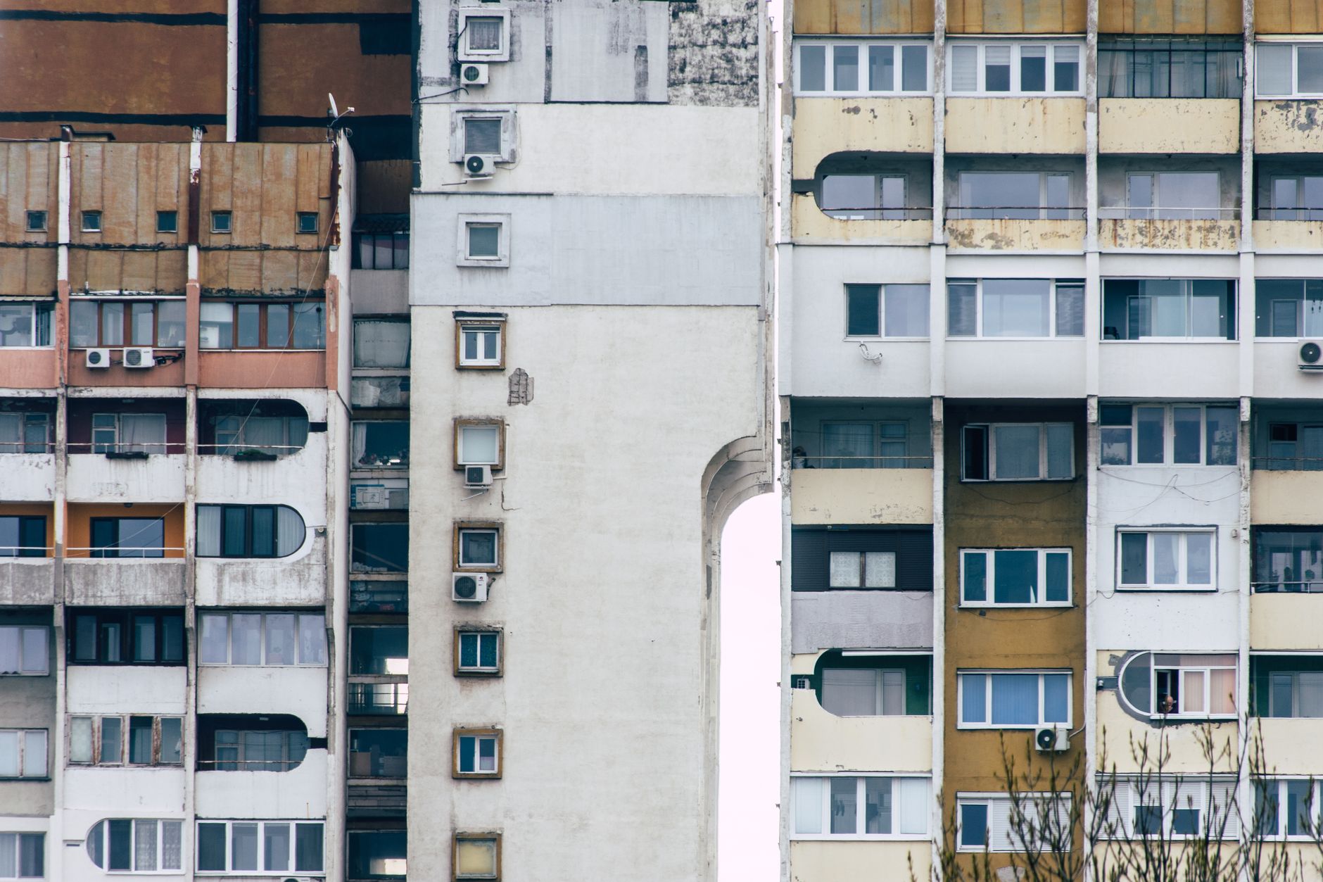 Detailed view of Soviet-style concrete apartment buildings with weathered facades and air conditioning units. — Trójmiasto