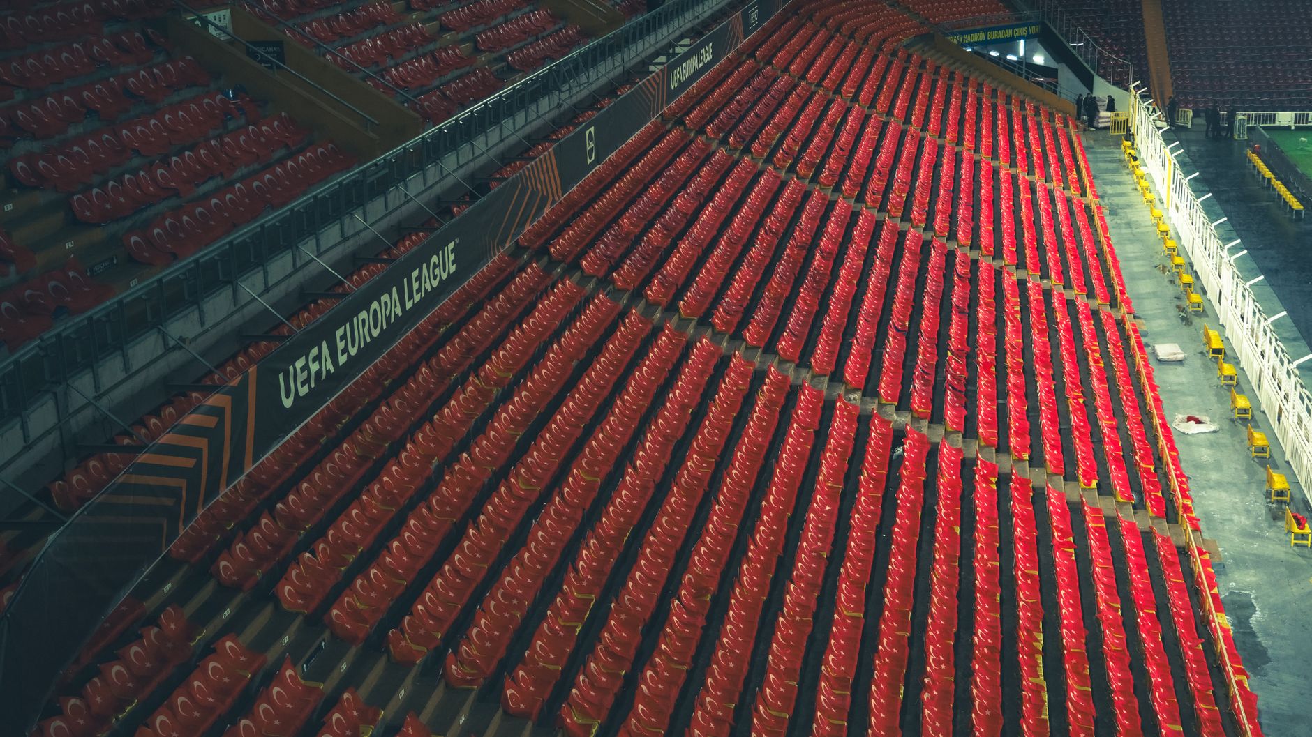 Rows of empty red seats in a UEFA Europa League stadium, captured from above. — Trójmiasto