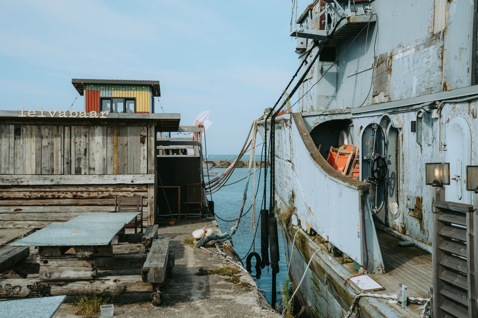 Explore the rustic charm of Tallinn's harbor with its wooden structures and historic vessels, perfect for maritime enthusiasts. — Trójmiasto