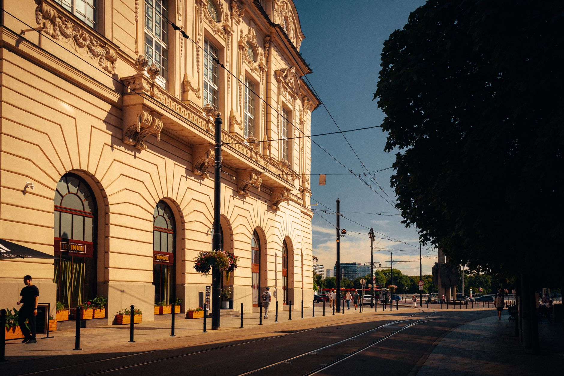 Charming streetscape in Bratislava with classic architecture and vibrant urban life under summer skies. — Trójmiasto
