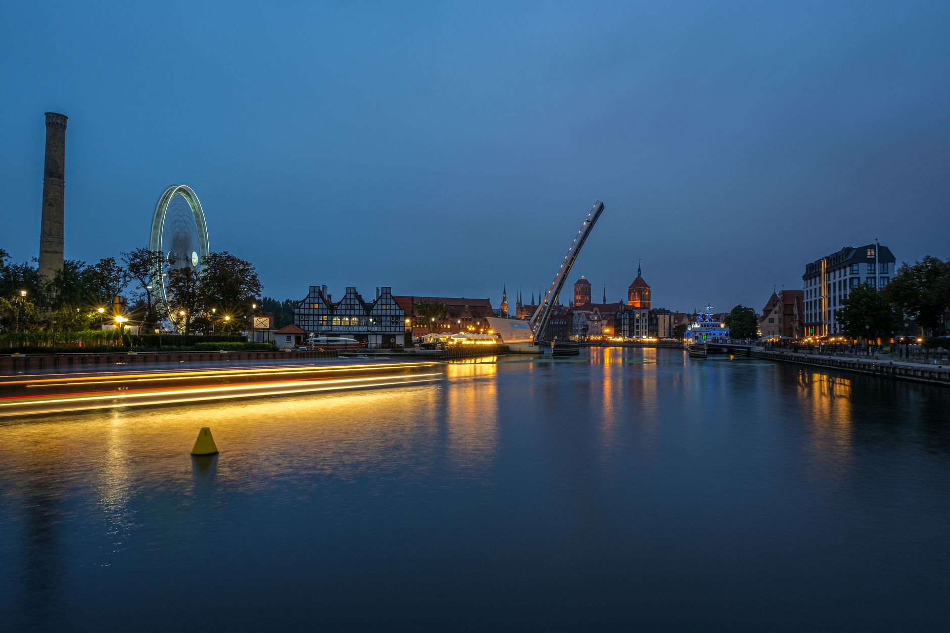Beautiful evening view of Gdańsk's illuminated cityscape along the Motława River. — Trójmiasto