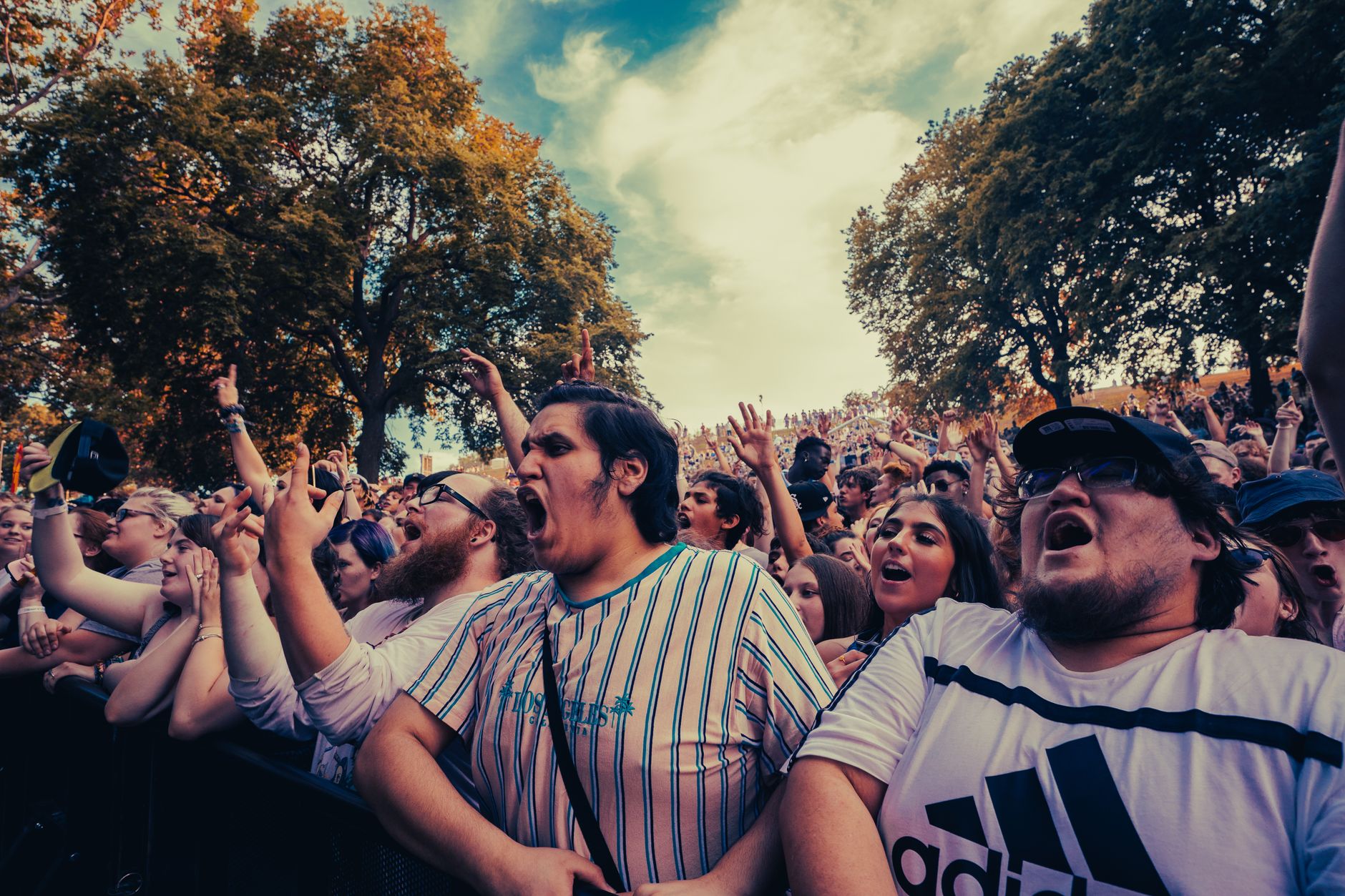 Excited festival-goers cheer at a vibrant outdoor concert with diverse attendees. — Trójmiasto