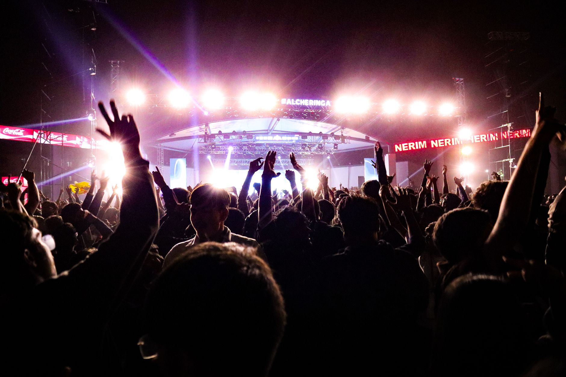 Energetic crowd enjoying a live concert under bright stage lights in Guwahati, India. — Trójmiasto
