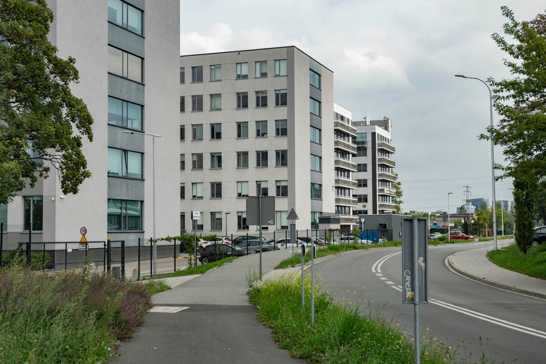 Street view of modern urban architecture and road in Wrocław, Poland, showcasing city life. — Trójmiasto