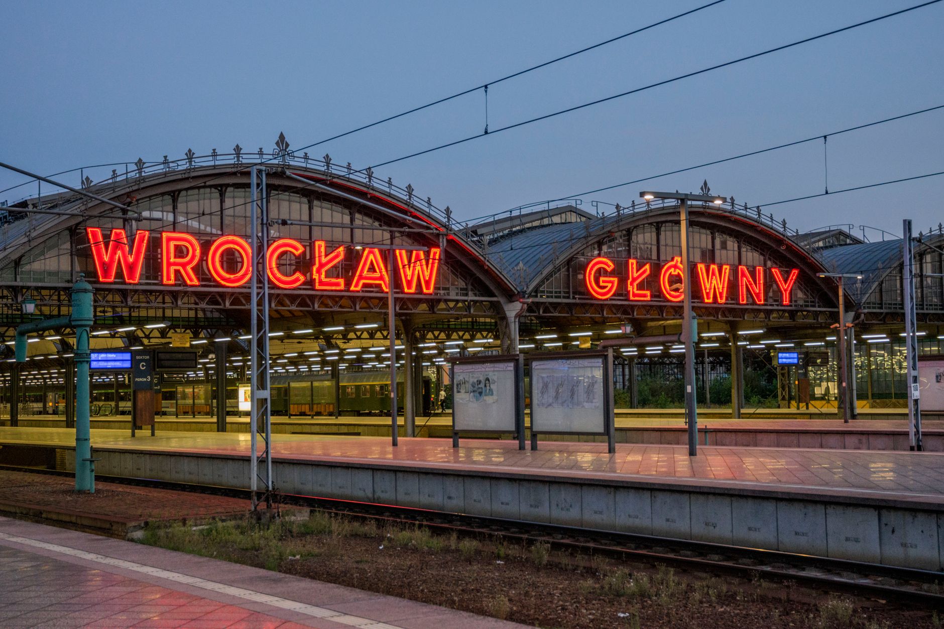 Neon signage at Wrocław Główny station, a key transportation hub in Poland. — Trójmiasto