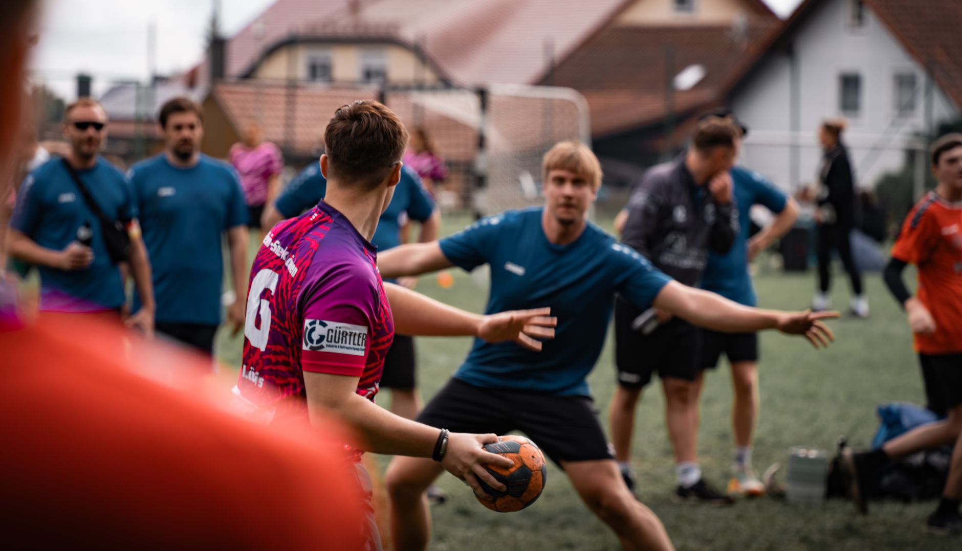 Outdoor handball practice session with players in action on a sports field in Oberviechtach, Germany. — Trójmiasto
