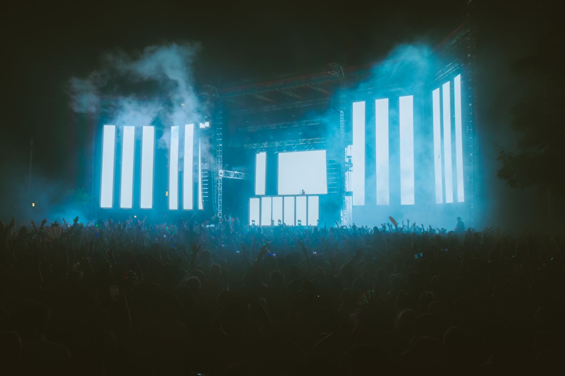 Energetic crowd at night music festival featuring large LED screens and colorful lighting effects. — Trójmiasto