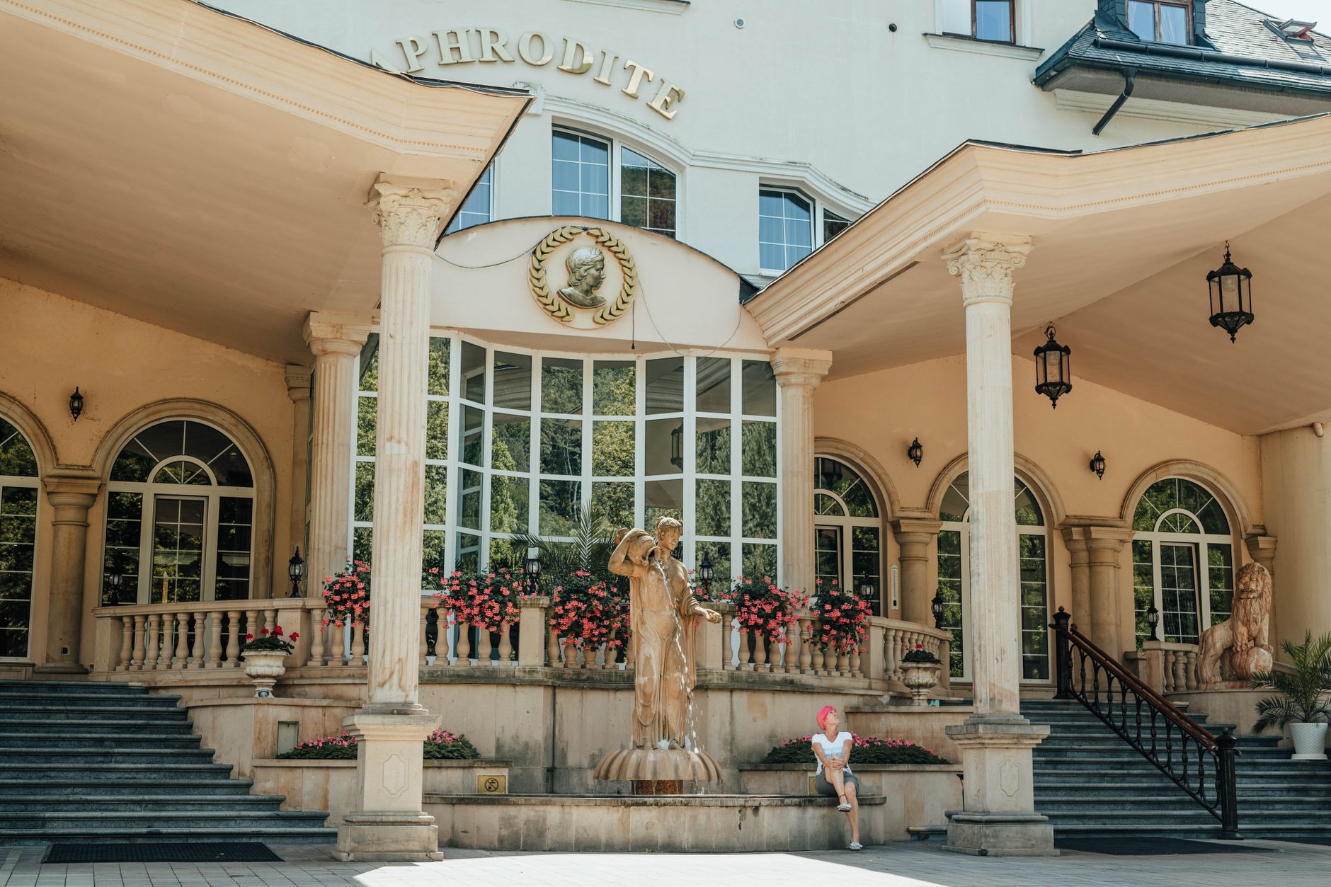 Elegant hotel entrance with grand columns, statues, and a fountain, exuding luxury and sophistication. — Trójmiasto