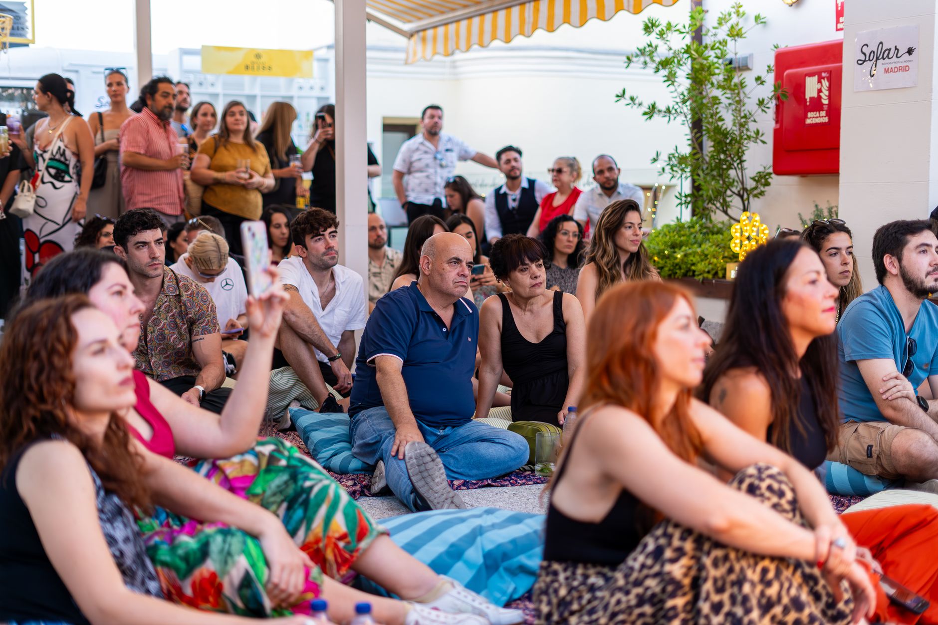 A diverse group enjoys a live music performance outdoors, capturing togetherness and cultural celebration. — Trójmiasto