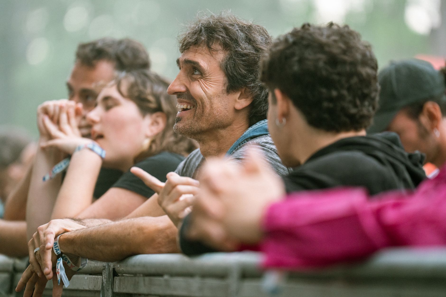 A diverse group of adults enjoying an outdoor music festival, showcasing joy and engagement. — Trójmiasto